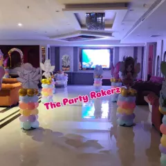The entrance and hall decoration for the butterfly-themed party. We placed themed balloon pillars with fairy cutouts along the walkway to welcome guests into the main event area.