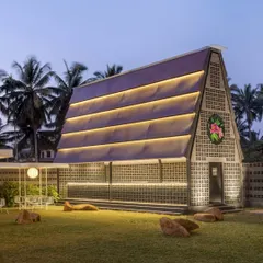 As dusk settles, the space transforms. This is our A-frame structure, beautifully lit to create a warm and inviting glow against the evening sky. It’s one of the many picturesque spots perfect for your evening gatherings.