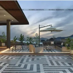 We designed this rooftop terrace for easy lounging with panoramic views. The space includes comfortable, all-weather sectional seating and a large umbrella for shade, all set upon a striking geometric-patterned floor.