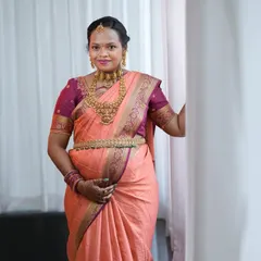 A beautiful portrait of our mom-to-be, Varsha. She is wearing a traditional temple choker, a long haram, and a matching vaddanam, creating a complete and graceful look.