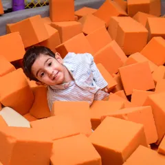 Peek-a-boo from the foam block pit! This is one of my favorite spots for kids to jump and play safely.