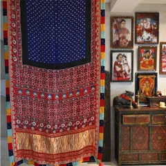 A saree is more than a garment; it is a canvas. Here, a hand-woven silk, dyed with traditional Bandhni and Ajrakh block-printing techniques, hangs as a testament to the artistry involved before it is even draped.