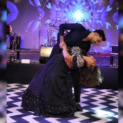 This is the kind of magical moment we love to create. A perfect dip on stage captures the romance and joy of a couple's first dance. We focus on creating beautiful poses like this that make your wedding photos and memories unforgettable.