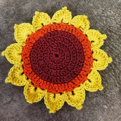 A close-up of a single, beautifully detailed sunflower coaster. The layered petals and rich colors make this a small piece of functional art for your home.