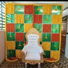 A vibrant backdrop for a Haldi or Mehendi ceremony, featuring a chequered pattern of orange and yellow marigolds. We've added a traditional white throne to complete the seating arrangement for the main ceremony.