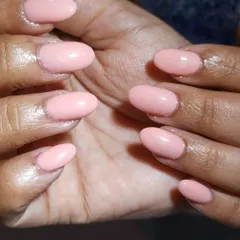 A classic soft peachy pink gel manicure. This is a universally flattering nude shade that is perfect for any occasion, from the office to a summer day out.
