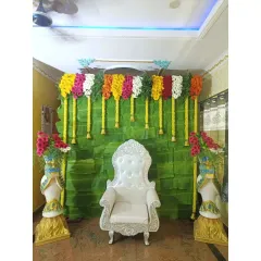 A classic Bale Shastra decoration with a full banana leaf backdrop and colorful garlands of fresh flowers. This style is timeless and perfect for the ceremony.