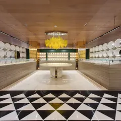 For this Ambala jewellery store, the goal was to create an atmosphere of bright, clean luxury. The lighting design balances powerful, high-quality illumination for the display cases with a stunning decorative centerpiece, a custom yellow chandelier that adds a bold, artistic statement to the retail environment.
