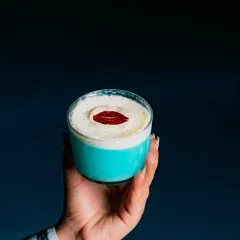 A kiss of creativity. This vibrant blue cocktail with a creamy foam top and a delicate sugar lip is as delicious as it is eye-catching.