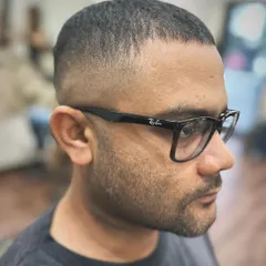 A side profile of a classic skin fade crew cut. Notice how the fade is graduated perfectly to complement the head shape. This is a fundamental style we master in my workshops.