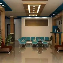 A practical and modern waiting room design featuring a multi-level false ceiling with recessed lighting. The layout provides ample seating, and the inclusion of potted plants adds a touch of nature to the commercial space.