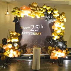 Another view of the elegant black and gold 25th anniversary backdrop. The organic balloon arch frames a custom-printed background, creating a luxurious and celebratory photo corner for the event.