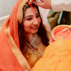 A precious moment from the wedding ceremony. The bride's makeup is designed to be long-lasting and picture-perfect, with a focus on glowing skin and beautifully defined eyes that radiate happiness.