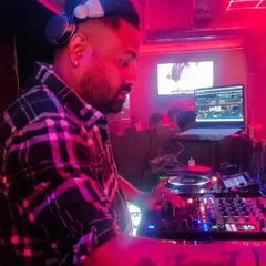 In the zone at Orange Mint Lounge, surrounded by the glow of the DJ console. This is where I blend tracks, control the visuals, and shape the energy of the night.