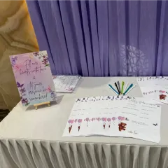 A guest book station for a baby shower, designed to collect heartfelt wishes. The setup includes a lovely sign and custom-printed cards for guests to write messages, ensuring the parents have cherished memories to look back on.