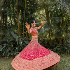 A joyful twirl from the bride in her stunning red lehenga. These portraits capture the happiness and beauty of the wedding day.
