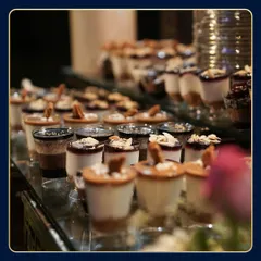 A close-up shot of our dessert shooters, with layers of cake, cream, and toppings. The shallow depth of field focuses on the intricate details of each individual dessert.