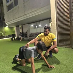 Proper form is everything. Here, our coach guides a young athlete through a bear crawl, an excellent functional exercise for building core strength and shoulder stability, crucial for any cricketer.