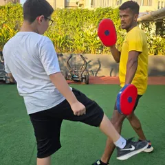 Kickboxing drills are fantastic for developing balance and lower-body power. Here, a young athlete executes a controlled kick, a key movement in our MMA fitness program.