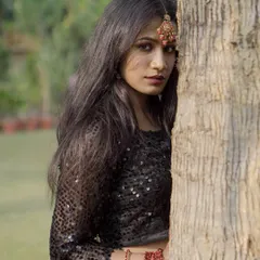 A more intense, direct-to-camera pose from the same ethnic fusion series. This highlights the model's expression and the details of her maang tikka.