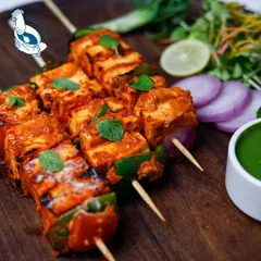 A classic done right. Our Traditional Paneer Tikka features soft cubes of paneer marinated in yogurt and spices, grilled with peppers and onions for that authentic tandoori flavor.