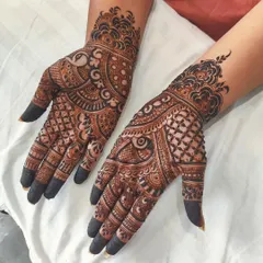 This traditional mehendi for Teej is dense with intricate patterns. It includes a peacock motif, checkerboard fills, and detailed finger designs, resulting in a rich and classic look.