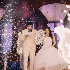 The couple's grand entrance to their reception, celebrated with a shower of confetti and cold pyro effects.