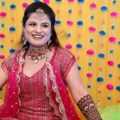 A radiant bride laughing during her mehndi ceremony.