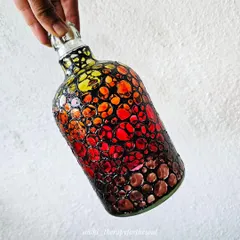 This bottle has a completely different feel, with a bubbling texture in a fiery gradient of yellow, orange, and red. It's a very tactile and abstract piece.