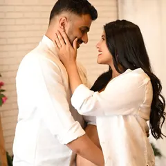 An intimate close-up of an expecting couple, capturing a gentle touch and a loving gaze during their maternity photoshoot.