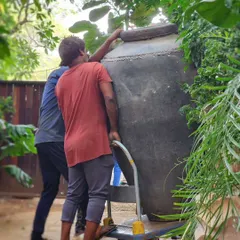 Things can get a little crazy at Plant People. Here's our team carefully maneuvering a giant, antique-style earthen urn for a client's villa project.