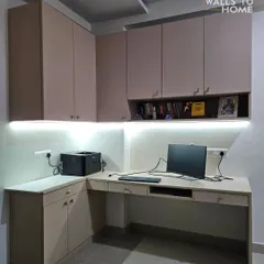 A minimalist and highly functional L-shaped home office setup. We designed this with ample overhead and base storage, an open shelf for books, and under-cabinet lighting for a well-lit workspace.