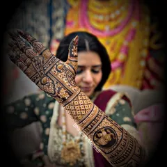 A bride showcasing her full-arm mehndi. This design includes intricate figures and patterns, a hallmark of our advanced bridal work.