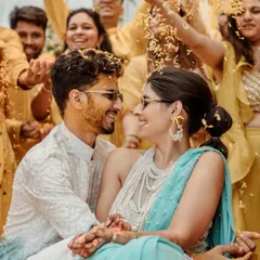 The pure, unscripted joy of a Haldi ceremony. Surrounded by loved ones and showered with petals, this candid moment is a burst of color, laughter, and authentic emotion.