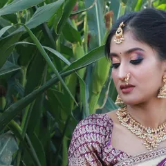 A close-up view highlighting the brocade blouse and traditional jewelry that complements this Langa Voni.