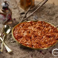 My Shahi Butter Chicken, a rich and creamy curry with tender pieces of chicken, available for order by the kilo. The dish is presented on a golden plate, emphasizing its royal flavor profile.