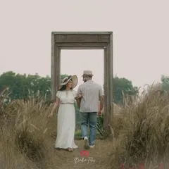 Walking into their future together. The couple walks through a door-like frame, symbolizing the start of a new chapter.