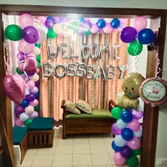 A fun 'Welcome Boss Baby' decoration for a newborn. This colorful setup includes a balloon arch and themed foil balloons.