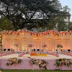 A wider view of the Mamera stage, showcasing the intricate floral work across the top and the soft, romantic lighting that enhances the pink and white color palette.