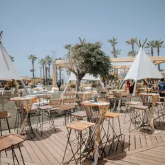 A chic and relaxed beachside setup for a wedding event in Antalya, Turkey. The teepee tents and casual high-top seating created a perfect bohemian vibe against the coastal backdrop.