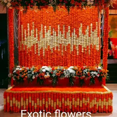 This massive backdrop features a unique soundwave pattern meticulously created with thousands of orange and white marigold flowers. It's a perfect example of how we blend traditional materials with contemporary design for a high-impact result.