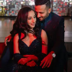An intimate Sangeet portrait with dramatic red lighting. The moody atmosphere and close embrace create a passionate and cinematic feel for this Mumbai wedding.