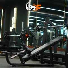 The strength training area features top-of-the-line equipment, including various benches and racks, to ensure you can perform exercises safely and effectively.