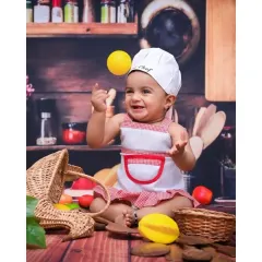 Here is a shot from my popular 'Little Chef' theme. This little one is having a blast playing with props in a miniature kitchen setup, creating such a playful and dynamic portrait.