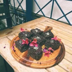A tray of our decadent chocolate brownies, garnished with edible flowers. Perfect for catering or just a treat for yourself.