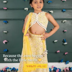 Because the 'aww' begins with the little twirls. This little one is wearing my sunshine yellow mirror-work lehenga, complete with a pearl-tasseled crop top and a lightweight dupatta, perfect for a Haldi ceremony.