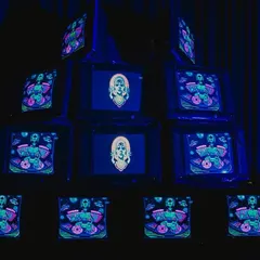 An installation of stacked vintage television sets displaying psychedelic, custom-made visuals. This retro-tech art piece was a major focal point and conversation starter.
