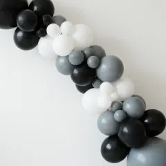 This minimalist balloon garland shows how a simple color palette of black, grey, and white can create a modern and elegant look. It's a versatile piece that can be used to decorate a wall, frame a doorway, or accent a main stage.