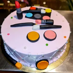 The perfect cake for a makeup enthusiast. This red velvet cheesecake is topped with a variety of edible, handcrafted makeup items, including lipstick, eyeshadow palettes, and brushes.