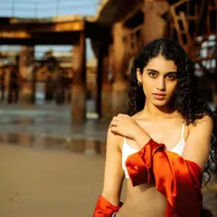 A direct, confident look against the rustic backdrop of the pier. This shot is all about capturing a powerful presence in a natural environment.